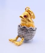 A silver chick egg pendant. 2 cm high.