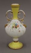A Minton porcelain vase decorated with flowers. 20.5 cm high.