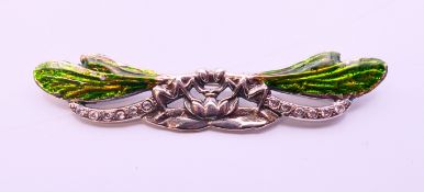 A silver dragonfly brooch. 7 cm long.