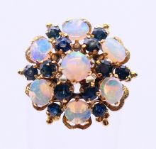 An 18k opal and sapphire cluster ring. Ring size L/M.