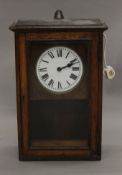 An early 20th century oak-cased electric wall clock. 58 cm high.