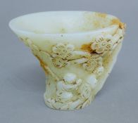 A carved stone libation cup. 9 cm high.