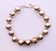 A silver bead bracelet. 18 cm long.