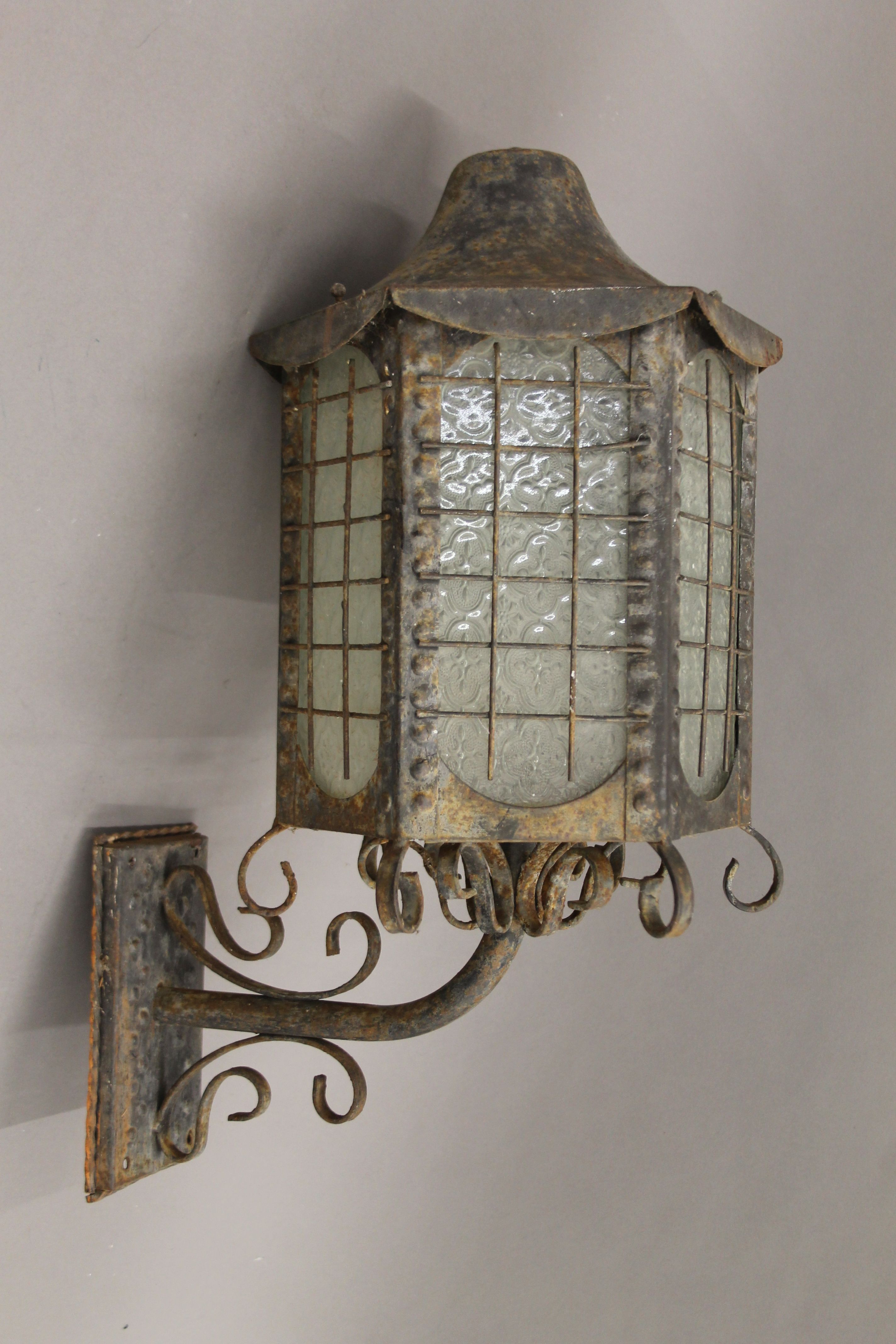 A wrought iron hanging lantern. 55 cm high.