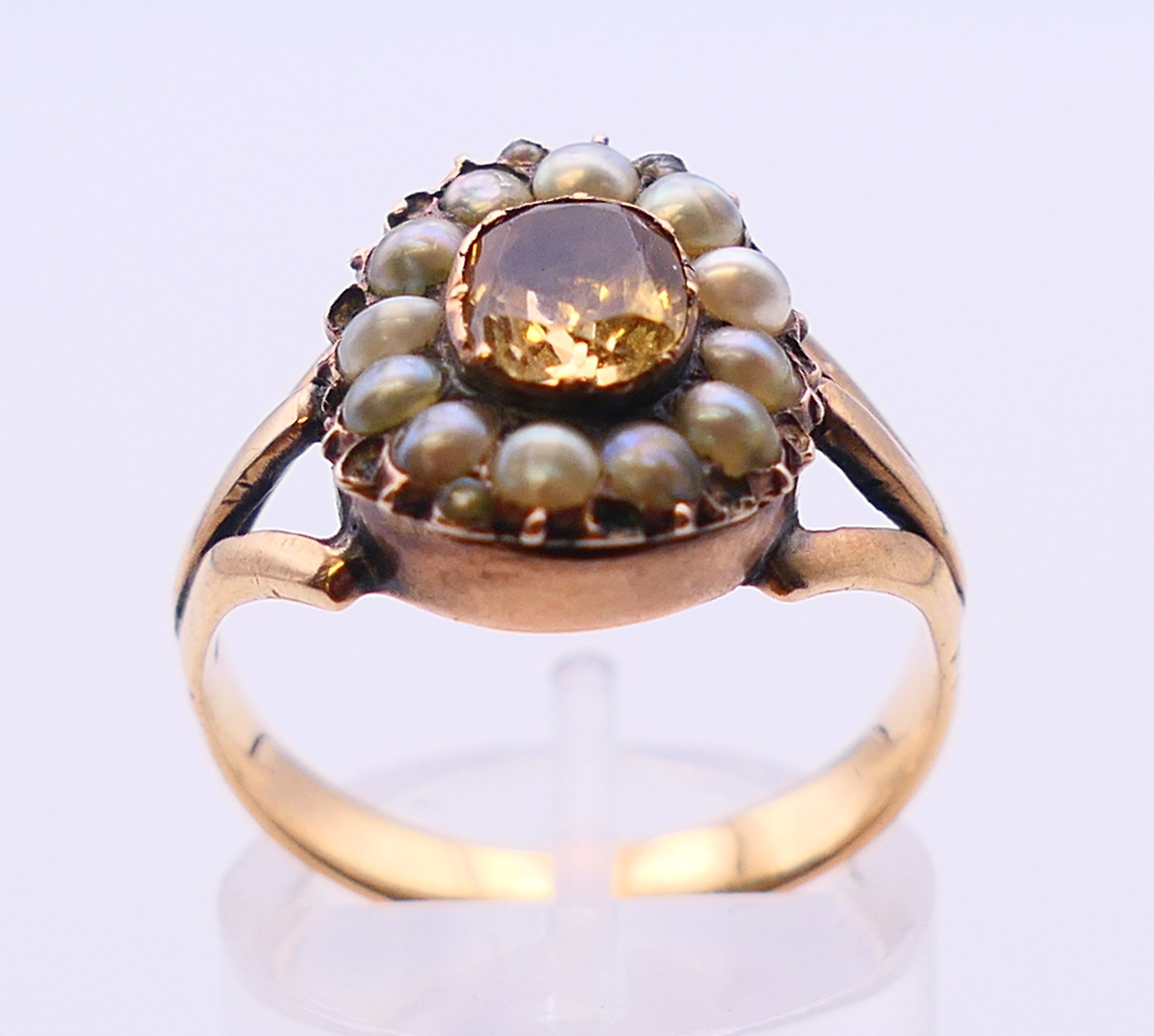 A Georgian unmarked gold Imperial topaz and seed pearl ring. Ring size N. - Image 2 of 5