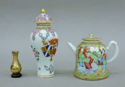 A 19th century Chinese famille rose teapot and armorial vase and a miniature vase.