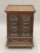 A small Victorian carved oak Revival cabinet with base drawer. 51.5 cm square.