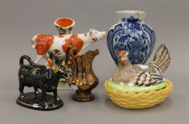 A group of 19th century Staffordshire pottery and a Delft vase. The latter 24 cm high.
