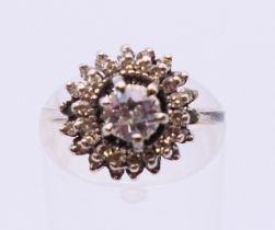 An unmarked 18 ct white gold and diamond cluster ring. Ring size M/N.