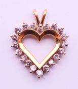 A 14 K gold, diamond heart shaped pendant. 2.5 cm high. 3.1 grammes total weight.
