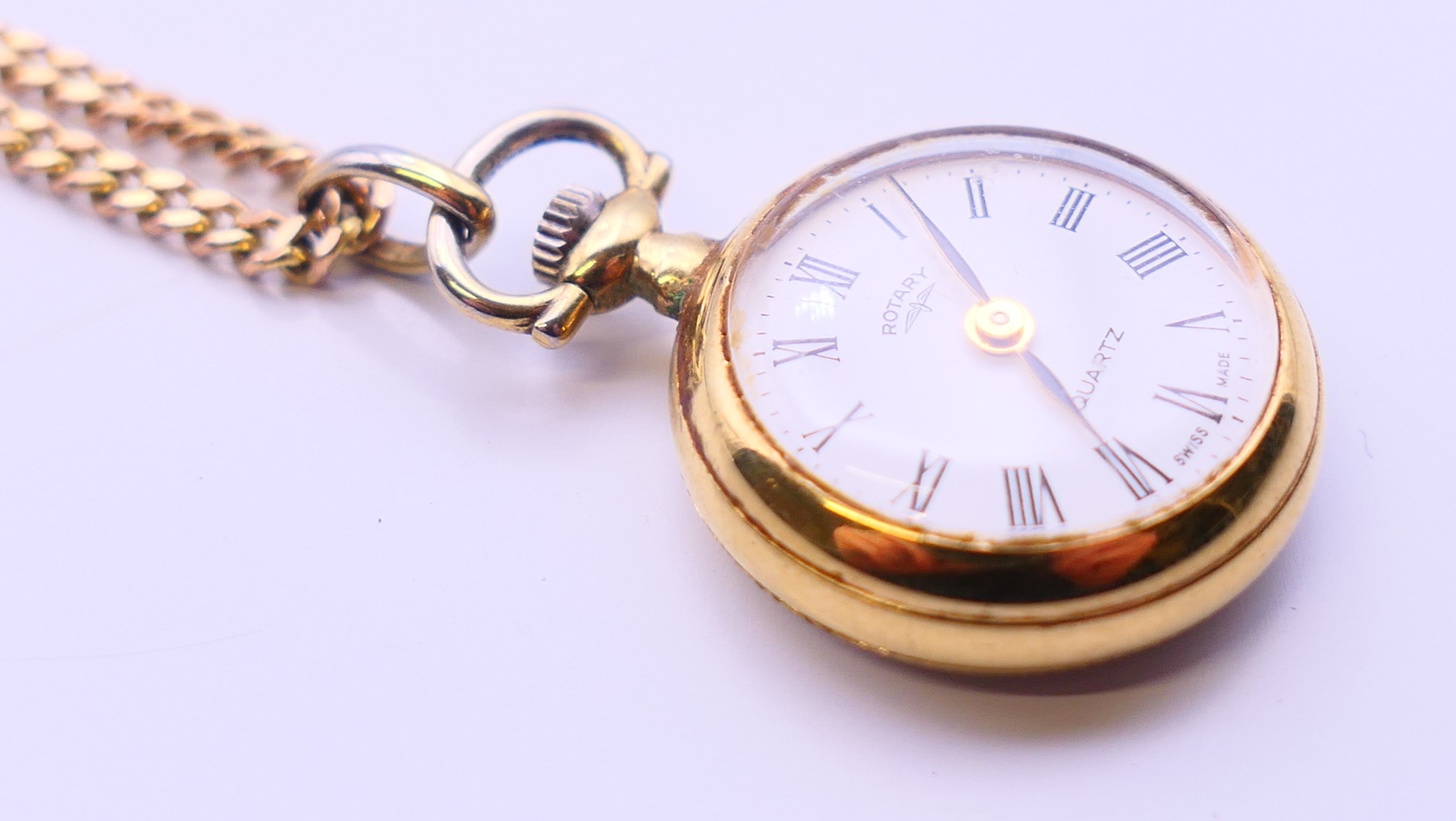 A Rotary fob watch on a 9 ct gold chain. 2.5 cm diameter, chain 62 cm long. The chain 6 grammes. - Image 4 of 8