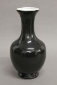 A Chinese black glazed porcelain vase (filled drill hole to base for lamp fitting). 35 cm high.