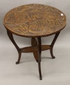 A Liberty and Co early 20th century centre table carved with the three wise monkeys.