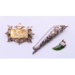 A Victorian silver brooch, a posy holder brooch and a silver and jade tiger tooth shaped pendant.
