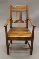 A 19th century oak open armchair. 55 cm wide.