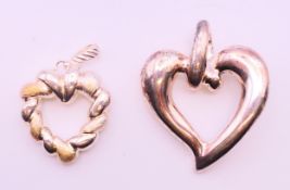 Two silver heart shaped pendants. The largest 5.5 cm high.