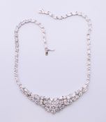 A silver cubic zirconia set articulated necklet. Approximately 43 cm long.