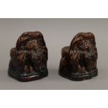 A pair of 19th century treacle glazed pottery lion's head sash window stoppers. 13.5 cm high.