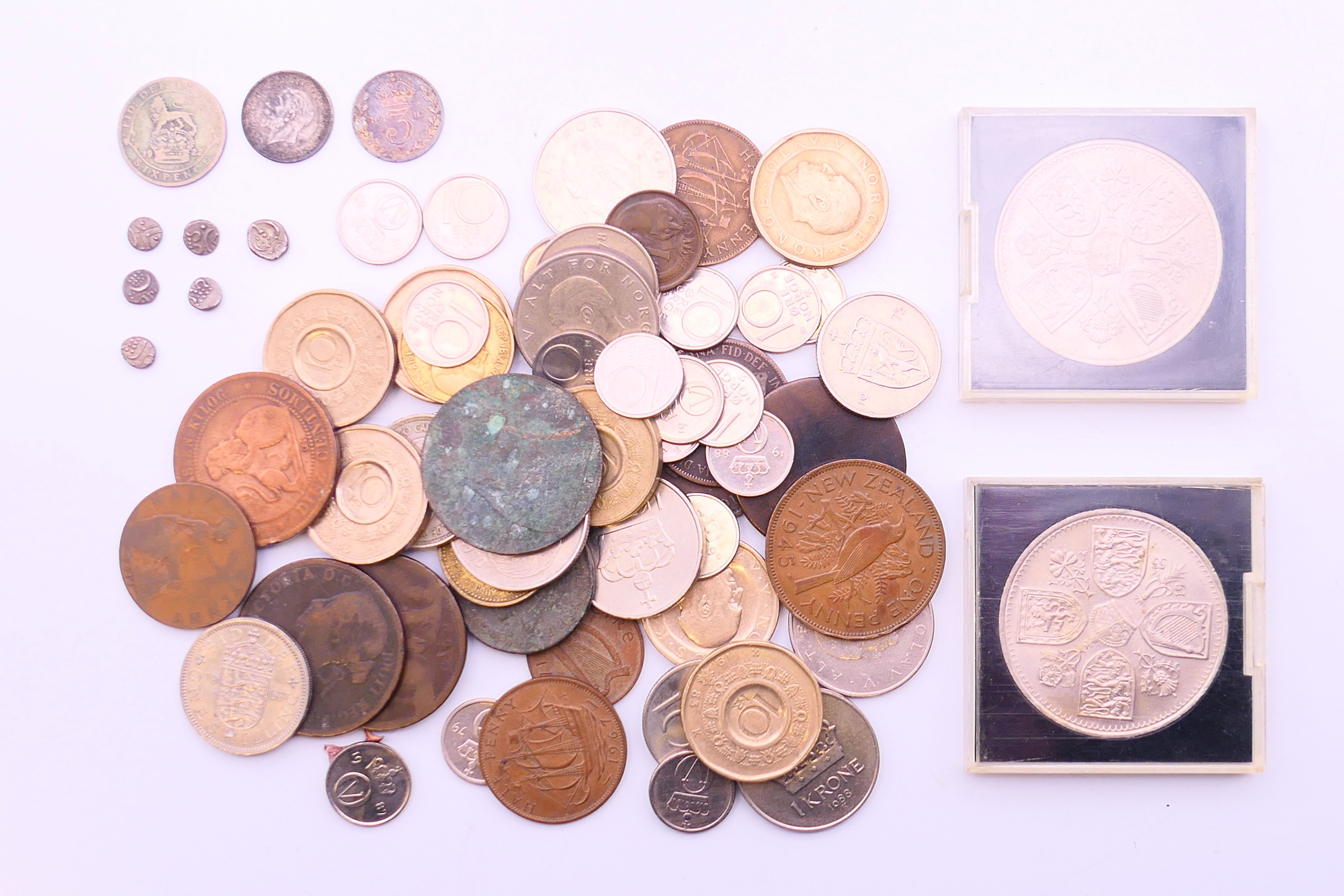 A quantity of various coins, including two silver threepenny coins, one silver sixpence coin,