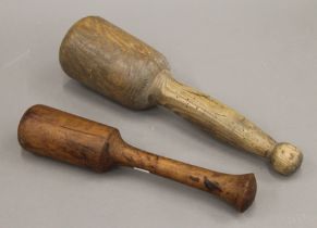 Two large wooden pestles. The largest 36 cm long.