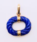 A Cartier 18 ct gold and lapis set pendant. 3 x 2.5 cm.