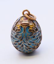 A silver and enamel egg pendant bearing Russian marks. 2.5 cm high.