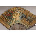 A large Oriental fan. 88 cm high.