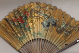 A large Oriental fan. 88 cm high.