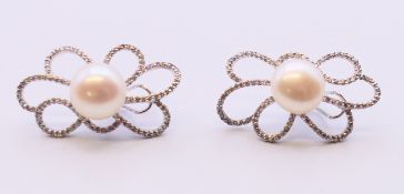 A pair of 14 K white gold, pearl and diamond earrings. 3.5 cm high.