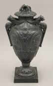 A Victorian black glazed pottery urn and cover. 39 cm high.