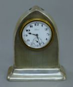 A small silver desk clock. 10.5 cm high.