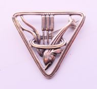 A silver triangle dolphin brooch. 3 cm high.