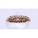 An 18 ct gold five-stone diamond ring. Ring size I/J.