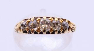 An 18 ct gold five-stone diamond ring. Ring size I/J.