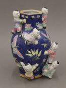 A Chinese hexagonal-shaped vase decorated in a blue ground with flora and fauna depicting The Happy