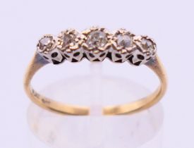 A 9 ct gold and platinum five stone diamond ring. Ring size O.