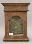 An oak-cased brass clock movement, the dial inscribed for William Tristle. 37.5 cm high overall.