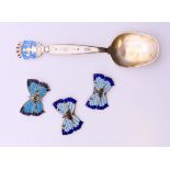 A David Andersen silver and enamel Oslo spoon, and three silver and enamel butterfly brooches.