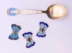 A David Andersen silver and enamel Oslo spoon, and three silver and enamel butterfly brooches.