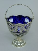 A Georgian silver bonbon basket with repaired blue glass liner. 12 cm high. 5.6 troy ounces.