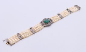 An emerald, pearl and diamond bracelet. 18 cm long.