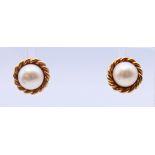 A pair of 9 ct gold and pearl earrings. 1 cm diameter.