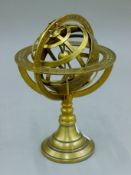 A brass Armillary sphere. 21 cm high.