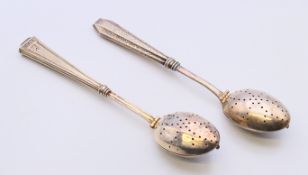 Two silver handled tea infusers. Largest 17 cm long.