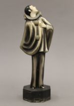 An Art Deco patinated bronze and ivory figurine mounted on a marble plinth base inscribed Roland