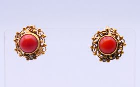 A pair of coral earrings. 1.25 cm diameter.