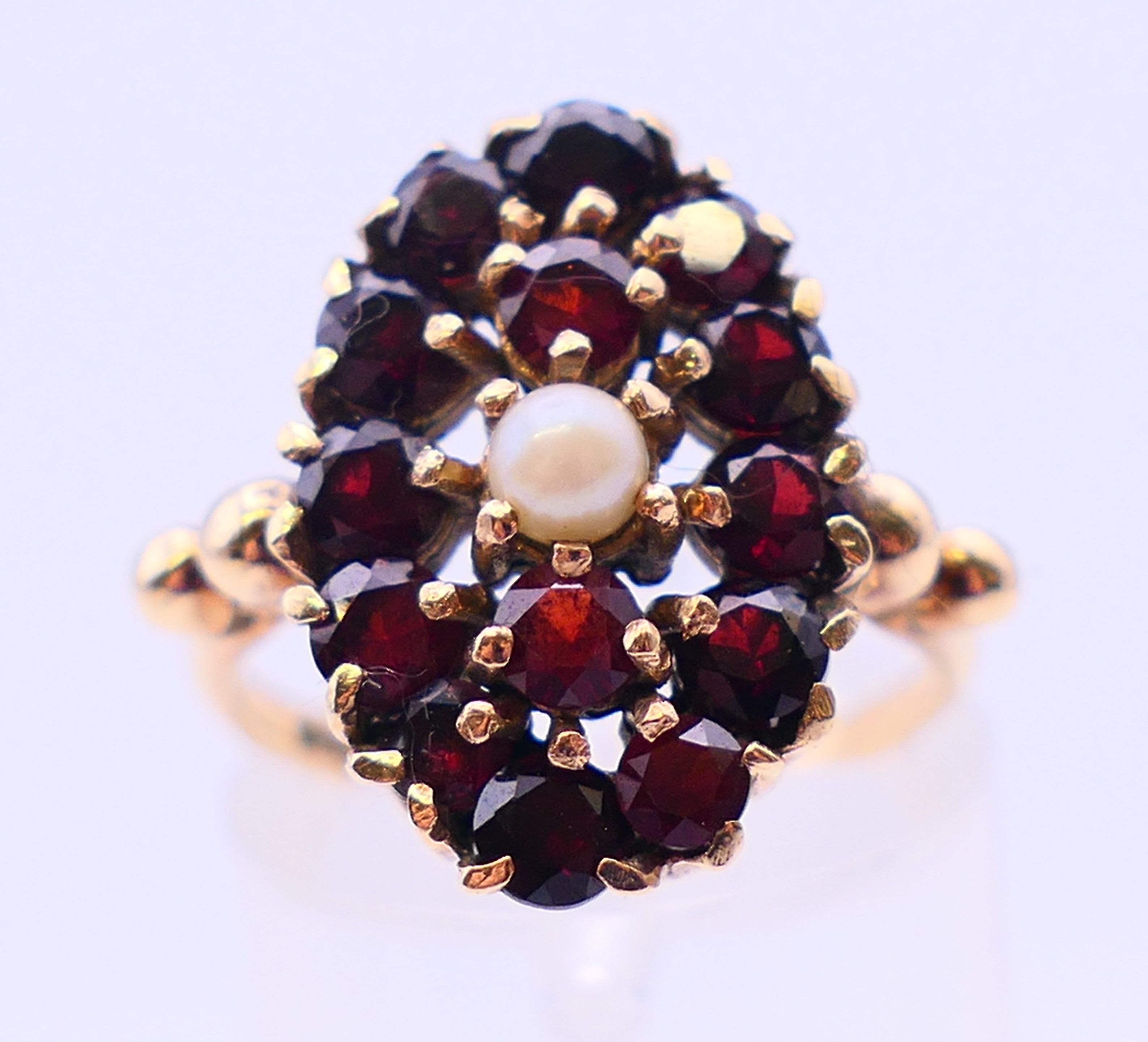 A 9 ct gold garnet and seed pearl ring. Ring size L. - Image 2 of 7