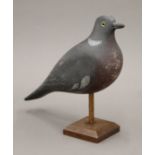 A vintage painted carved wooden pigeon decoy on stand. 32 cm long.