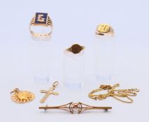 A quantity of 9 ct gold jewellery, including three rings, a chain, a cross pendant, etc. 21.