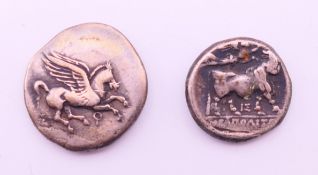 Two antiquity type coins. 1.25 cm and 1.75 cm diameter.